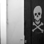 skull and bones at corridor's door