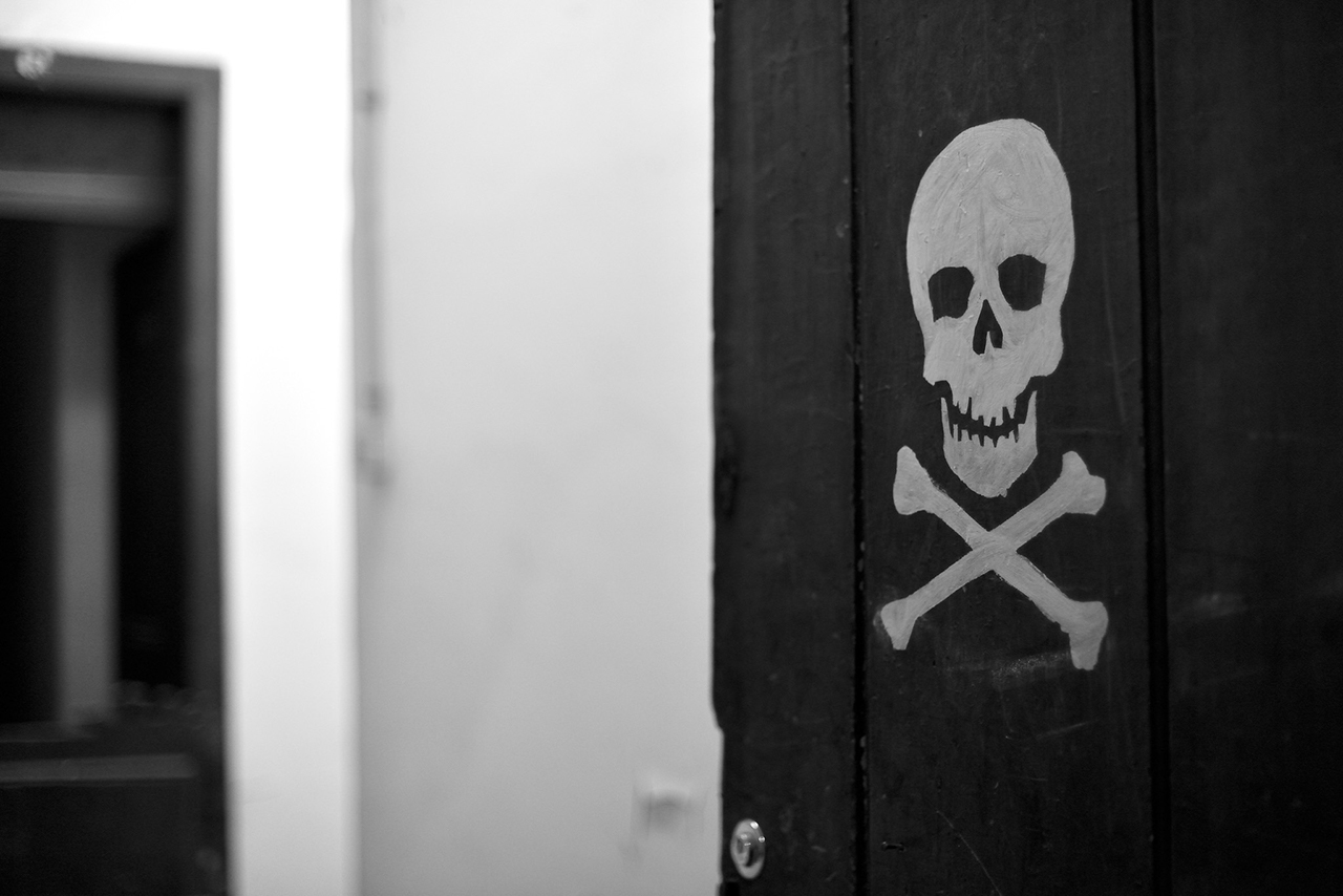 skull and bones at corridor's door